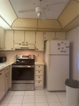 a kitchen with cabinets and white stainless steel appliances