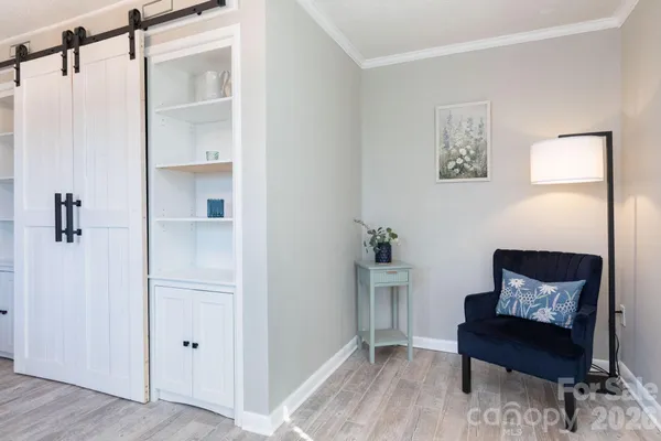 a view of a livingroom with furniture and a window