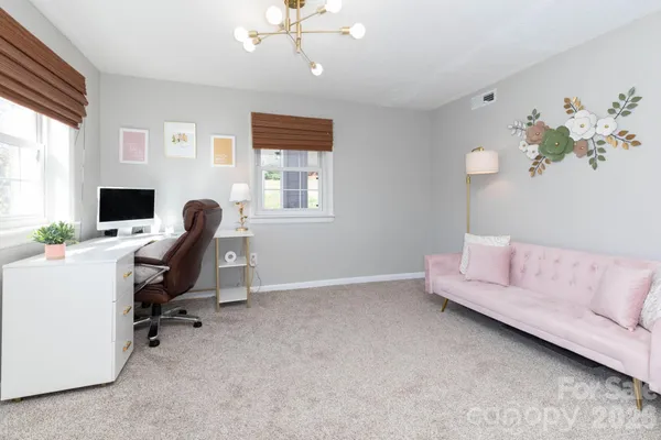 a view of a livingroom with workspace and a window