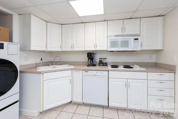 a kitchen with cabinets appliances a sink and a counter top