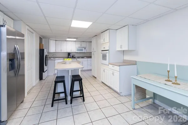 a kitchen with a sink appliances and cabinets
