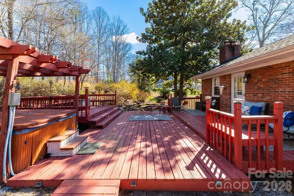 a view of a patio with table and chairs with wooden floor and fence