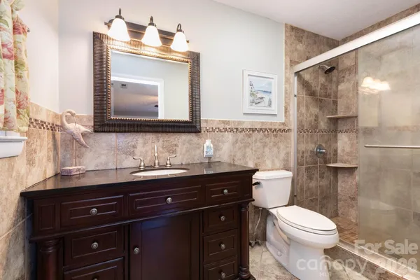 a bathroom with a toilet a sink and a mirror