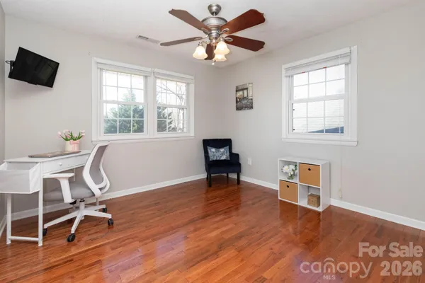 a workspace with wooden floor and a window