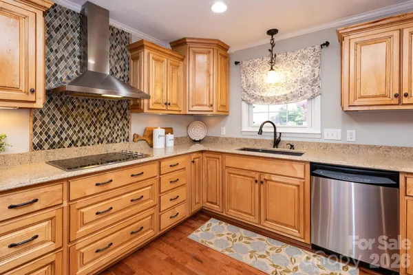 a kitchen with granite countertop a sink stainless steel appliances and cabinets