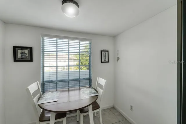 a dining room with furniture and window