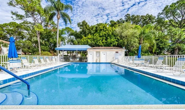 a view of a house with a backyard and a small pool