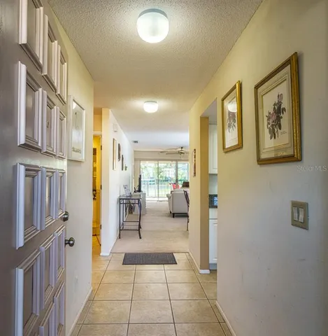 a hallway with a baby crib furniture and a window