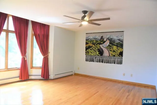 a view of a livingroom with wooden floor and a window