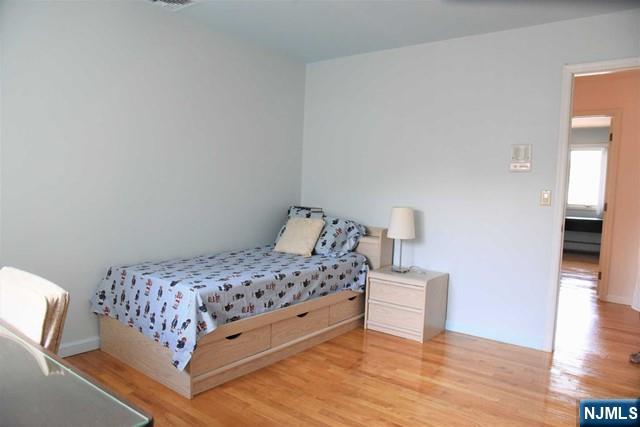 39 Irving Avenue Englewood Cliffs, NJ 07632 - Photo 21 of 31 a bedroom with a bed and wooden floor