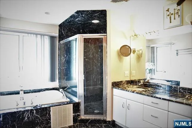 a bathroom with a granite countertop sink and a mirror