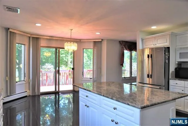a kitchen with counter top windows and kitchen view