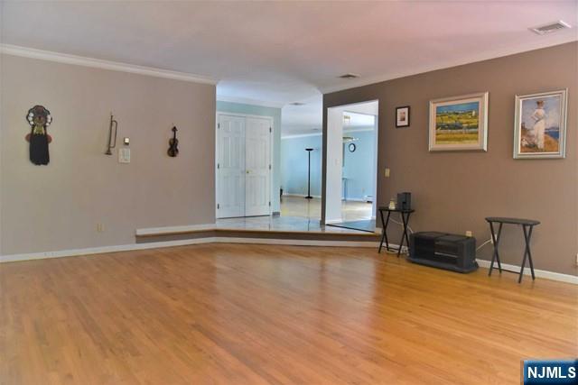 39 Irving Avenue Englewood Cliffs, NJ 07632 - Photo 9 of 31 a view of an empty room with wooden floor and a chair