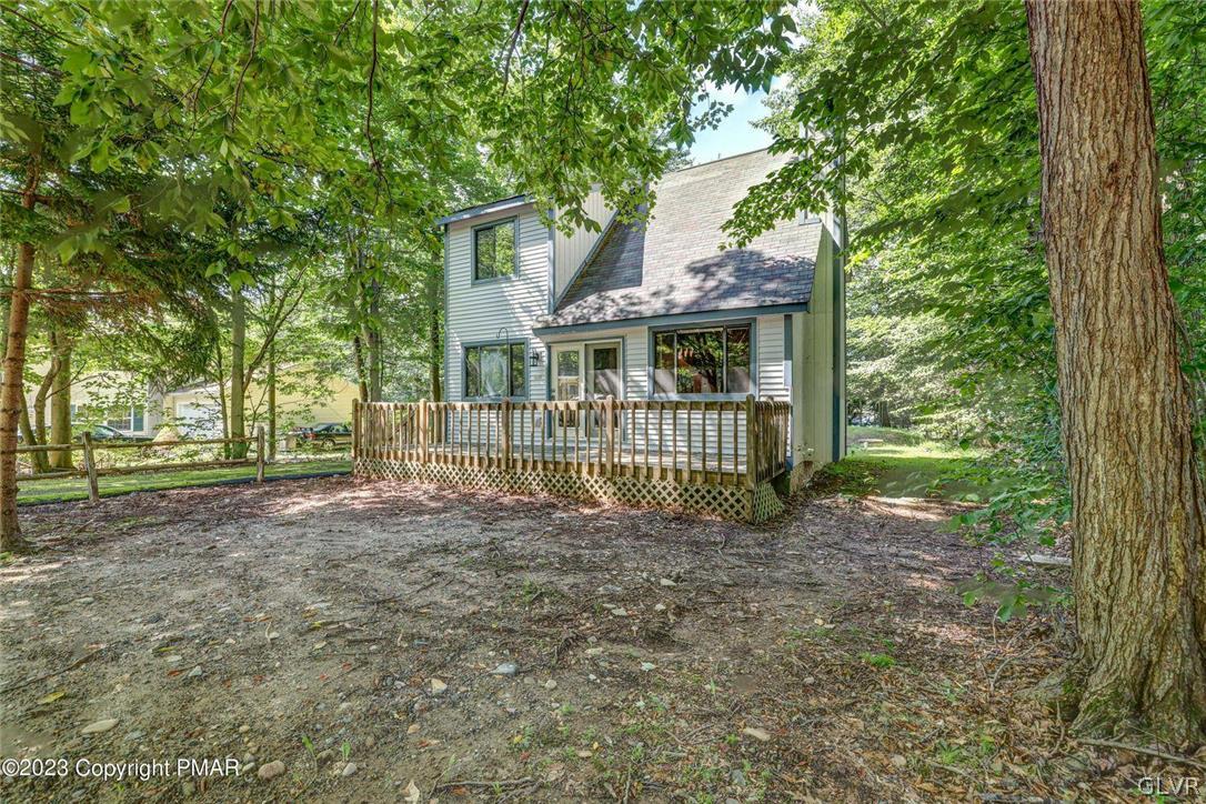 2150 Titania Road Tobyhanna, PA 18466 - Photo 1 of 31 a view of a house with a small yard and a large tree