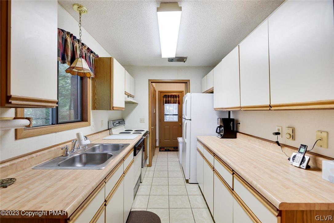 2150 Titania Road Tobyhanna, PA 18466 - Photo 13 of 31 a kitchen with a sink stove and cabinets