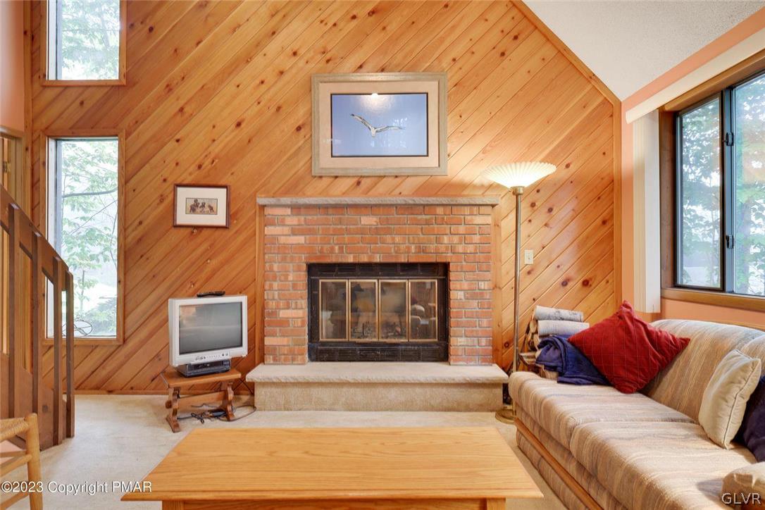 2150 Titania Road Tobyhanna, PA 18466 - Photo 7 of 31 a living room with furniture a fireplace and a large window
