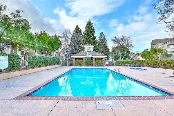 a view of swimming pool with a lounge chairs