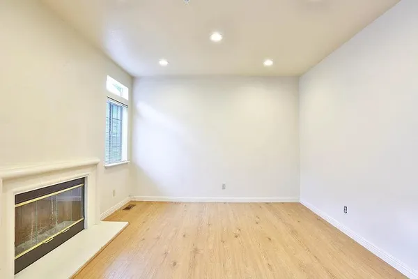 a view of an empty room and wooden floor