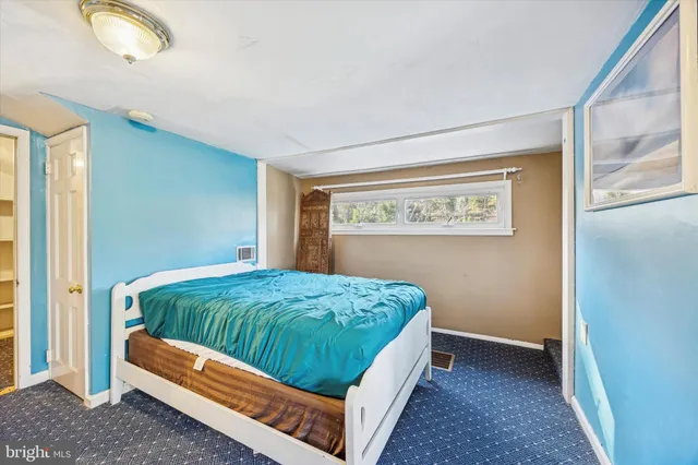 a bed room with a bed and a window