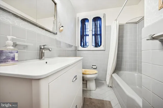 a bathroom with a sink a toilet and bathtub