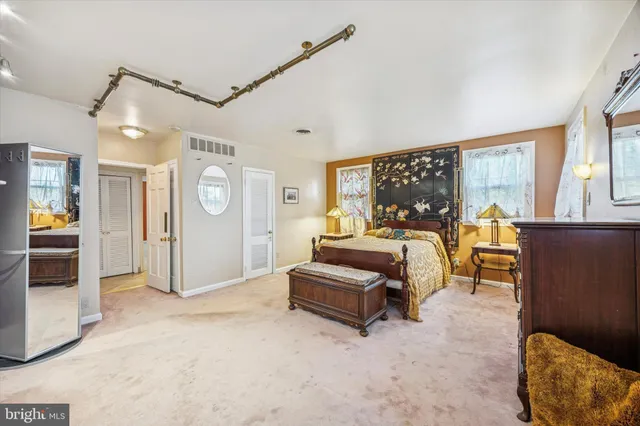 a bedroom with furniture and a large window