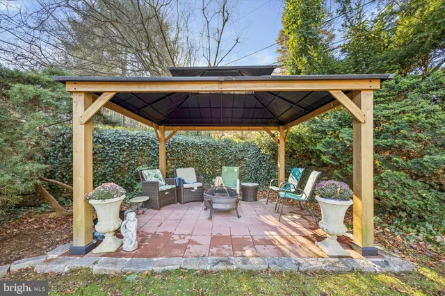 a view of a house with backyard and sitting area