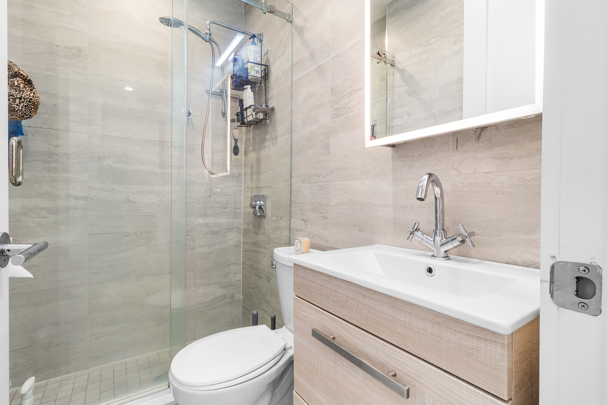 473 Bainbridge Street, Unit 2B Brooklyn, NY 11233 - Photo 9 of 15 a bathroom with a sink toilet and shower