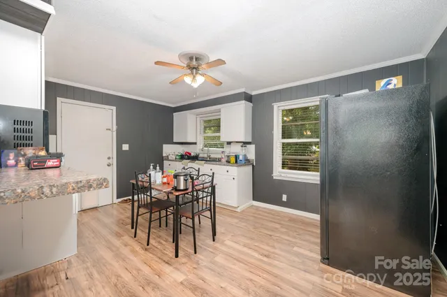 a view of a dining room with furniture and a chandelier