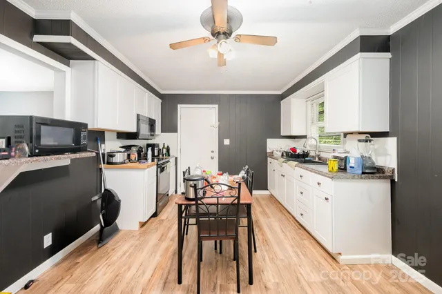 a kitchen with granite countertop lots of counter top space and appliances