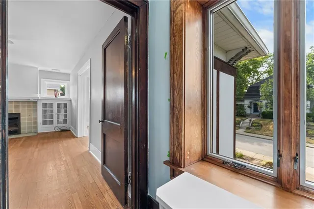 a view of a room with wooden floor and windows