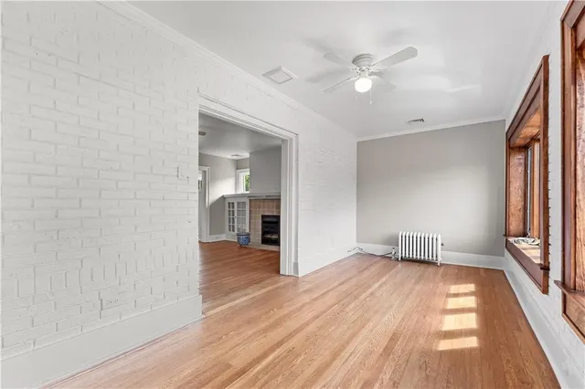 wooden floor in an empty room with a window