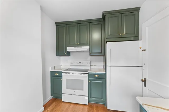 a kitchen with a refrigerator sink and stove
