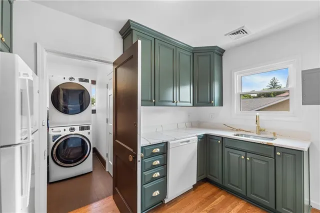 a kitchen with a sink a washer and dryer