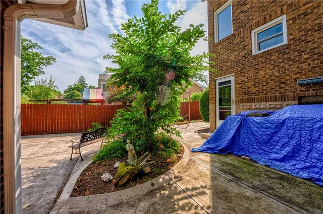 a view of backyard with outdoor seating and plants