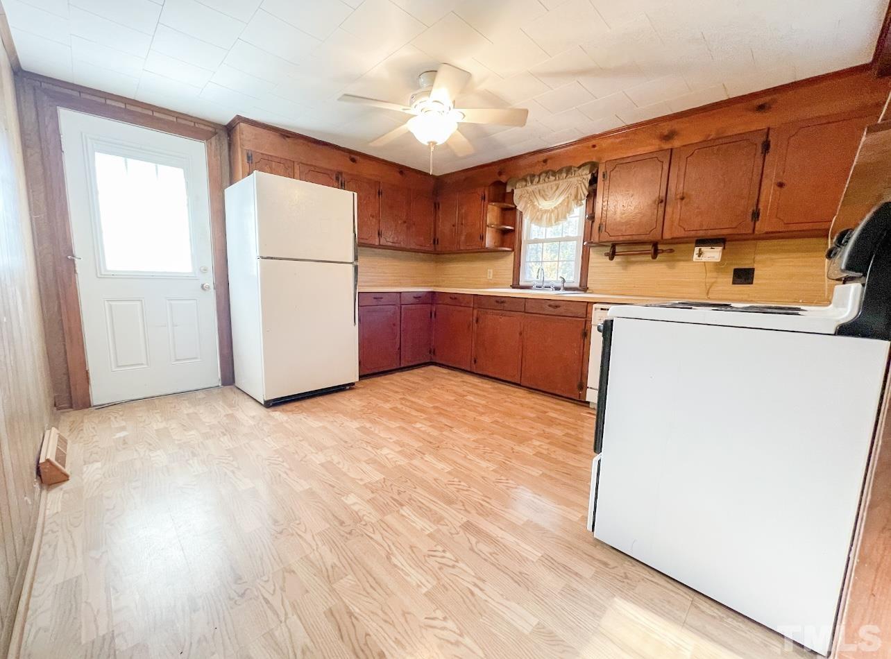 8718 Oxford Road Timberlake, NC 27583 - Photo 8 of 27 a kitchen with stainless steel appliances a refrigerator and a stove top oven