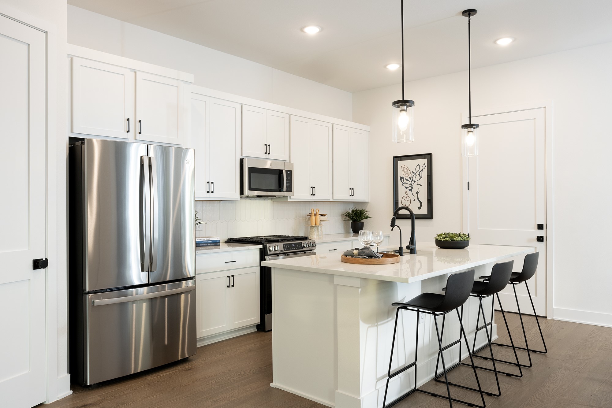 1320 Sweet Bark Street Austin, TX 78745 - Photo 8 of 13 a kitchen with stainless steel appliances granite countertop a refrigerator a stove a sink a dining table and chairs