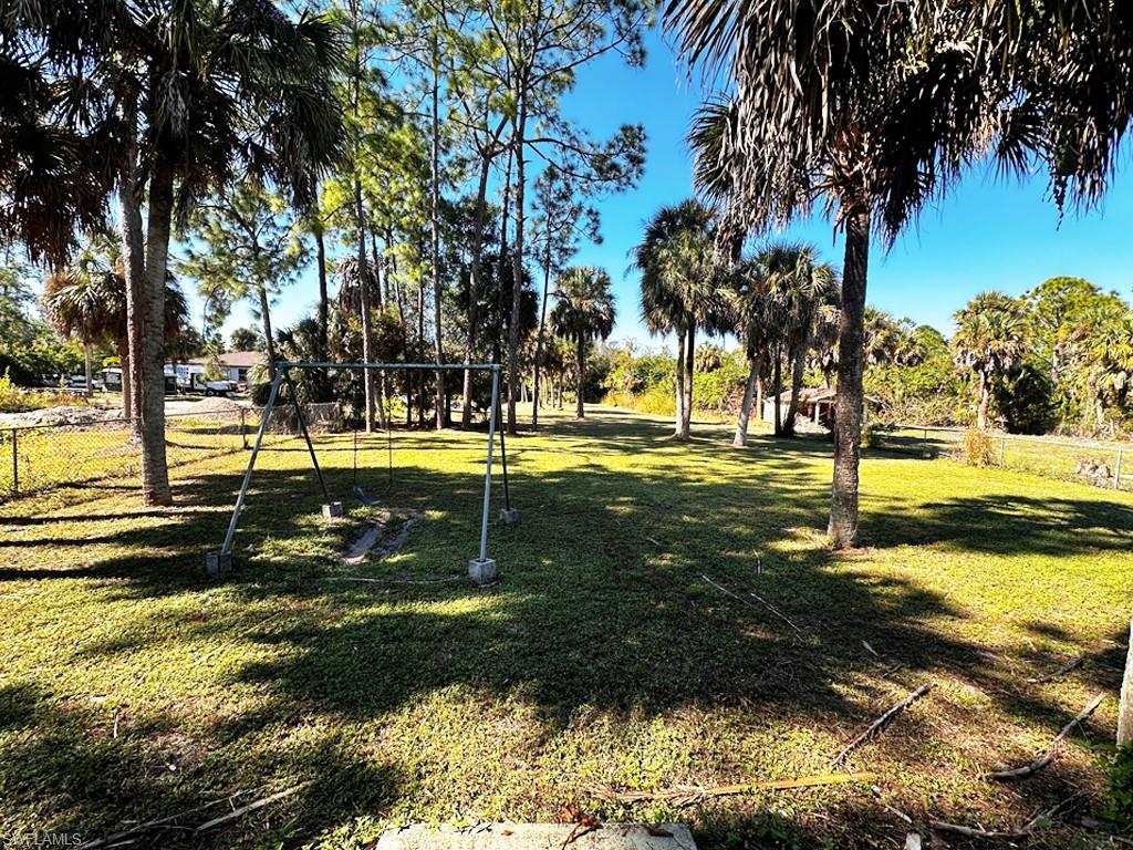 231 14th Street Northeast Naples, FL 34120 - Photo 3 of 13 Expansive cleared backyard.