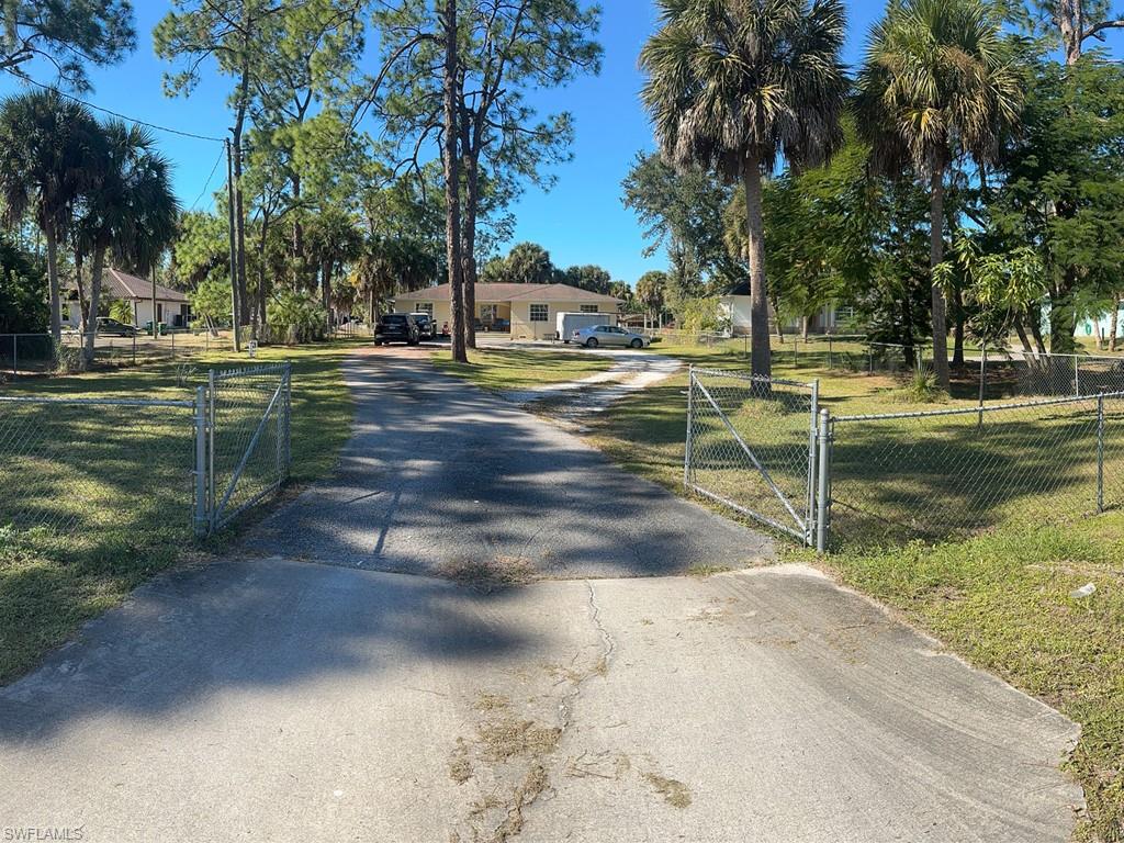 231 14th Street Northeast Naples, FL 34120 - Photo 5 of 13 View of asphalt driveway with a gated entry and a gate