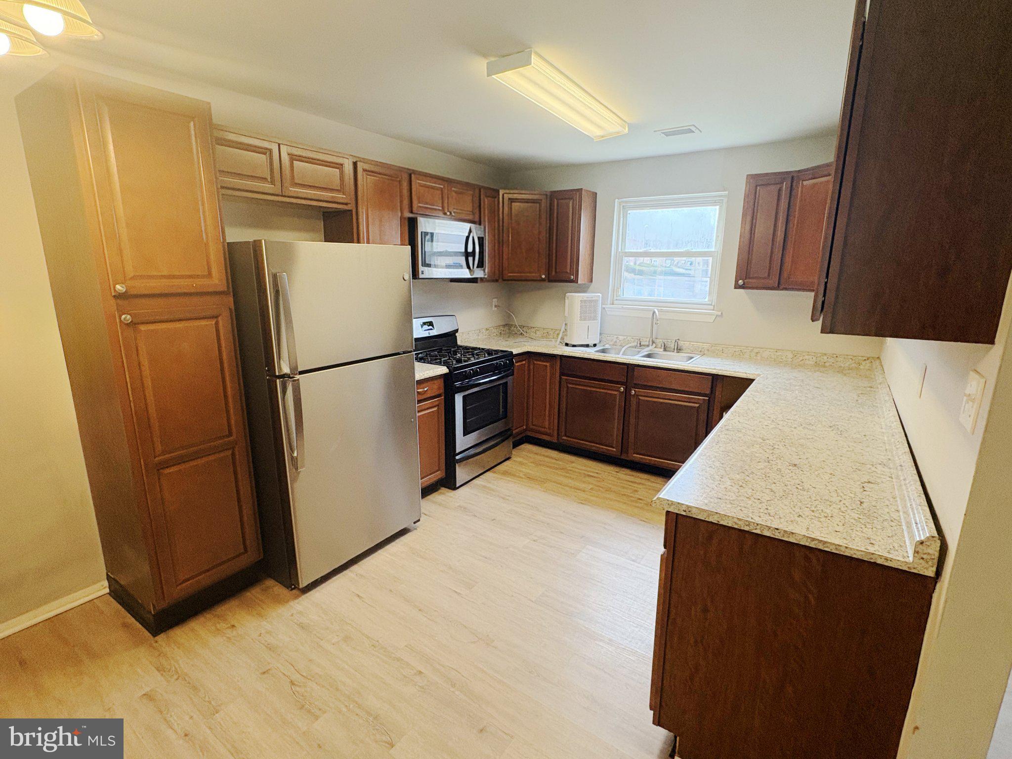 308 Via Cascata Drive Clementon, NJ 08021 - Photo 9 of 23 Modern kitchen with warm wood tones.