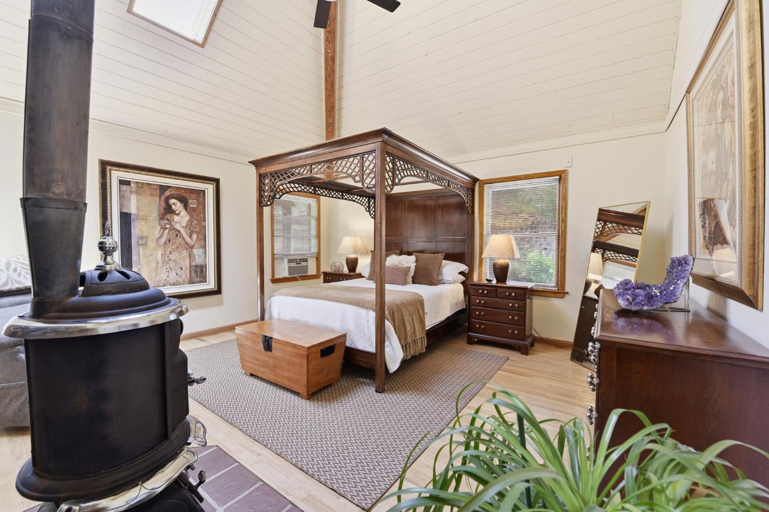 7201 Happy Valley Road Somerset, CA 95684 - Photo 24 of 75 The primary bedroom has a cathedral ceiling, and a wood stove of ambiance and warmth.