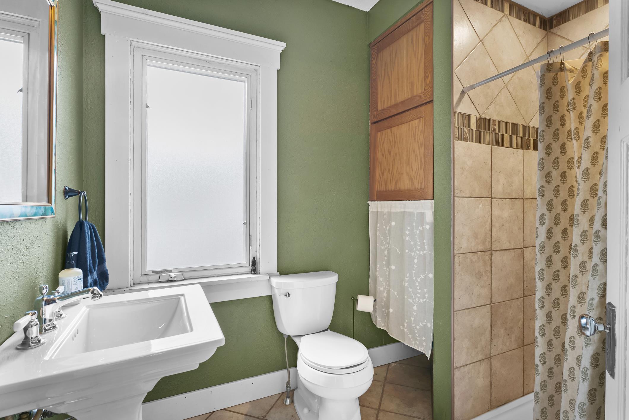 1617 Madison Street Manitowoc, WI 54220 - Photo 16 of 34 Tiled shower, pedestal sink and updates.