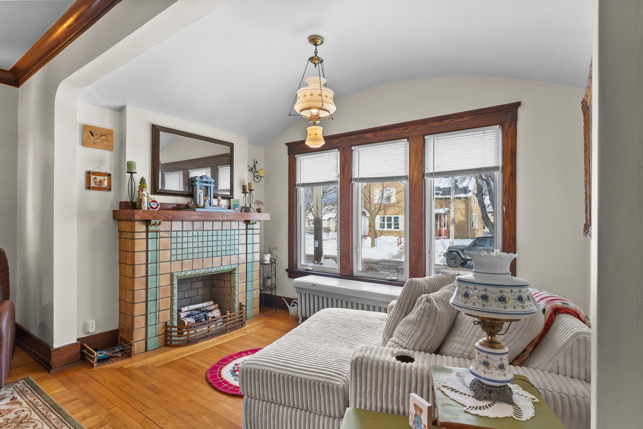 1617 Madison Street Manitowoc, WI 54220 - Photo 7 of 34 Decorative tiled fireplace, wood floors, beautiful trim. Large front windows face North.