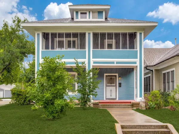a front view of a house with a yard and porch