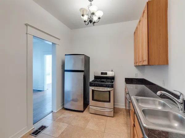 a kitchen that has a sink cabinets and stainless steel appliances
