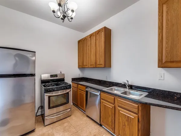 a kitchen with stainless steel appliances a stove sink and cabinets