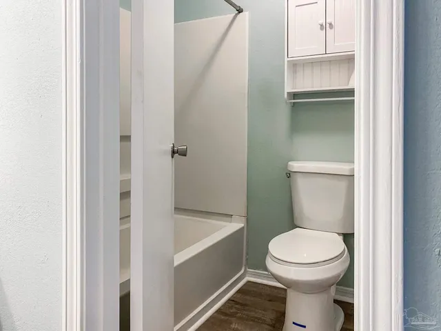a white toilet sitting next to a bathroom sink