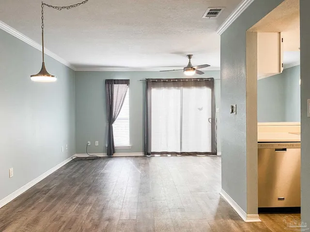 a view of a room with wooden floor and white walls