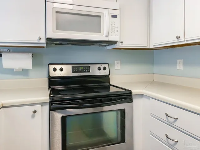 a stove top oven sitting inside of a kitchen