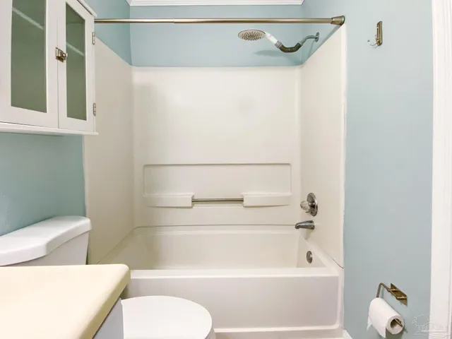 a bathroom with a toilet and a shower