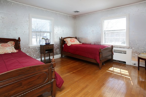 41 Sheldon Road Newton, MA 02459 - Photo 6 of 7 a bedroom with a bed and wooden floor